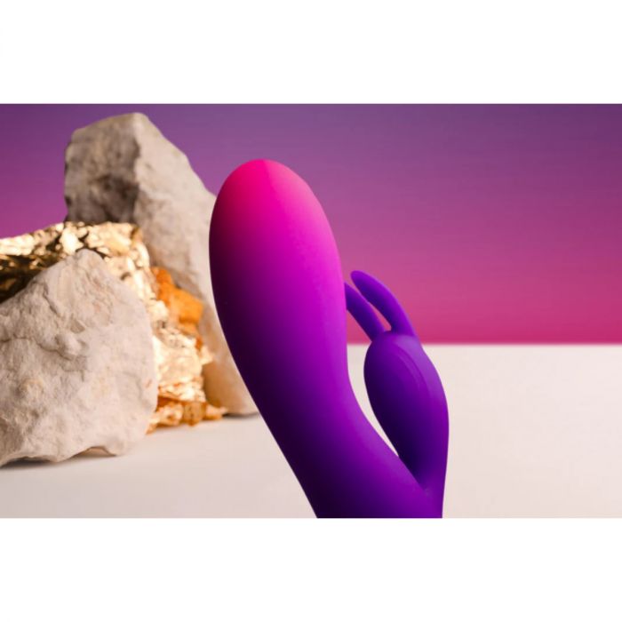 a purple object sitting next to some rocks