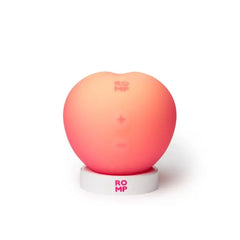 Romp Pink Peach silicone clitoral vibrator with suction feature, compact design and textured surface for enhanced pleasure.