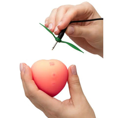 Romp Pink Peach silicone clitoral vibrator with suction and vibration features, designed for intimate pleasure.