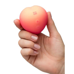 Romp Pink Peach silicone clitoral vibrator with suction feature, designed for targeted stimulation and pleasure.