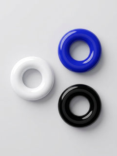 JoyRings Doughnut Stretchy Cock Rings (3 Pack) displayed in white, blue and black; luxury stretchy cock rings photographed from above.