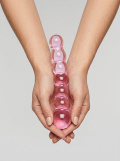 Close-up of the Spectrum Ribbed Glass Dildo emphasizing its high-quality hypoallergenic glass material.