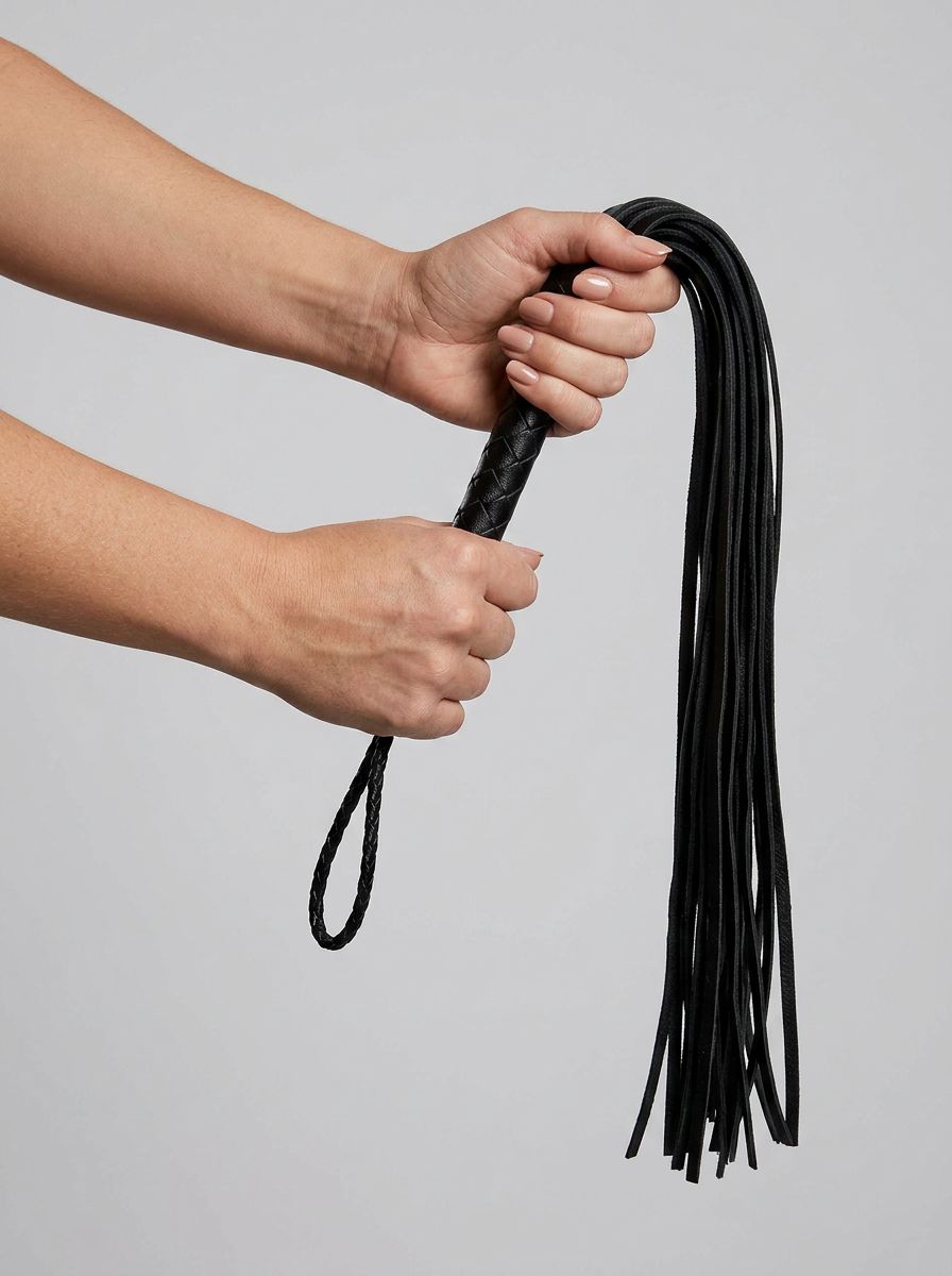 Elegant Prowler RED Hard Whip - 34 Inch Leather BDSM Impact Flogger showcasing exquisite leather craftsmanship and a comfortable grip, ideal for refined impact play.