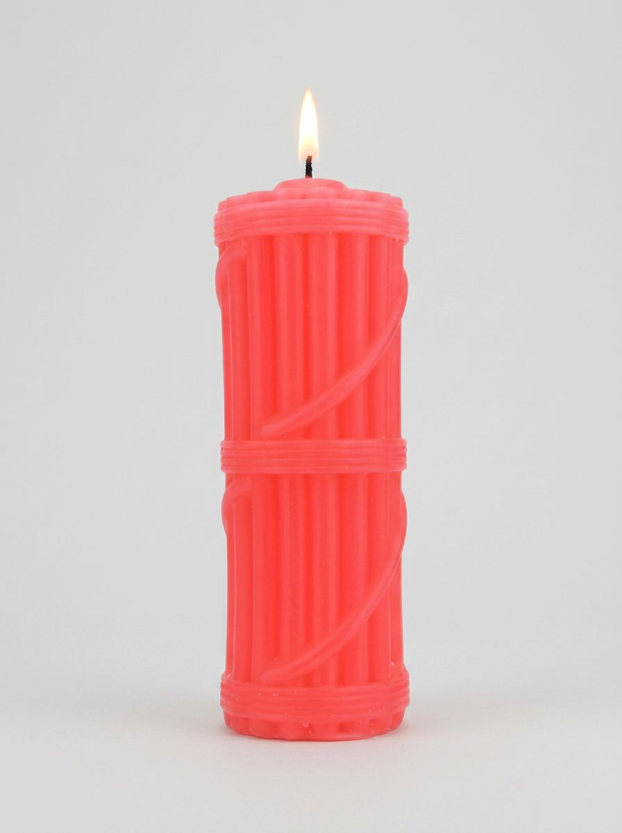 Hot wax candle by Bound to Play for BDSM pleasure, shown melting and dripping on a surface, emphasizing sensual and tempting ambiance.