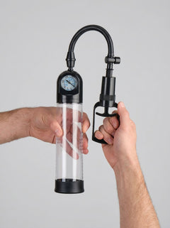 Me You Us Gauge Penis Pump – Suction Pump for Enhanced Size, Stamina, and Confidence, displayed upright with clear chamber, integrated gauge and ergonomic manual handle