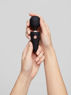 Elegant Le Wand Mini Micro Rechargeable Massage Wand Vibrator showcased beside travel essentials - perfect luxury mini massage wand for on-the-go pleasure.