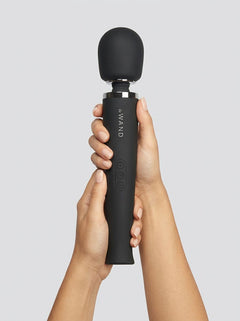 Le Wand Rechargeable Wand Massager Vibrator Black held upright in both hands, showcasing its premium black finish and rounded silicone head.