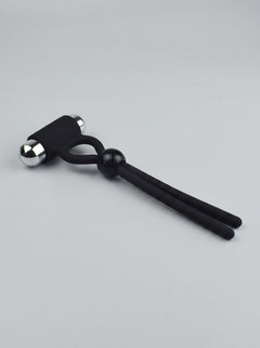 Rev-Rings Vibrating Adjustable Cock Ring presented in a stylish setting, emphasising its adjustable nature and powerful vibration for a lavish pleasure experience.