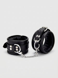 BOUND Leather Wrist Restraints featuring black leather with seductive silver accents, perfect for enhancing intimate experiences.