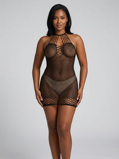 A model wearing the Pink Lipstick All Talk Fishnet Cut Out Dress in Black, showcasing the seductive body-hugging design, featuring intricate fishnet details and a bold silhouette.