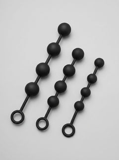 Large Silicone Anal Beads for Advanced Play in 3 Sizes by Scandals, displaying the beads' elegant black colour and luxurious texture.