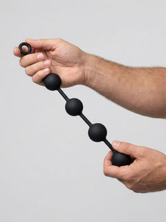 Prowler RED Silicone Anal Beads in hands, displaying an elegant grasp, focusing on comfort and sophistication.