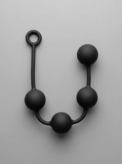 Prowler RED Silicone Anal Beads in a stylish pose, showcasing their smooth, tapered design for luxury anal play.