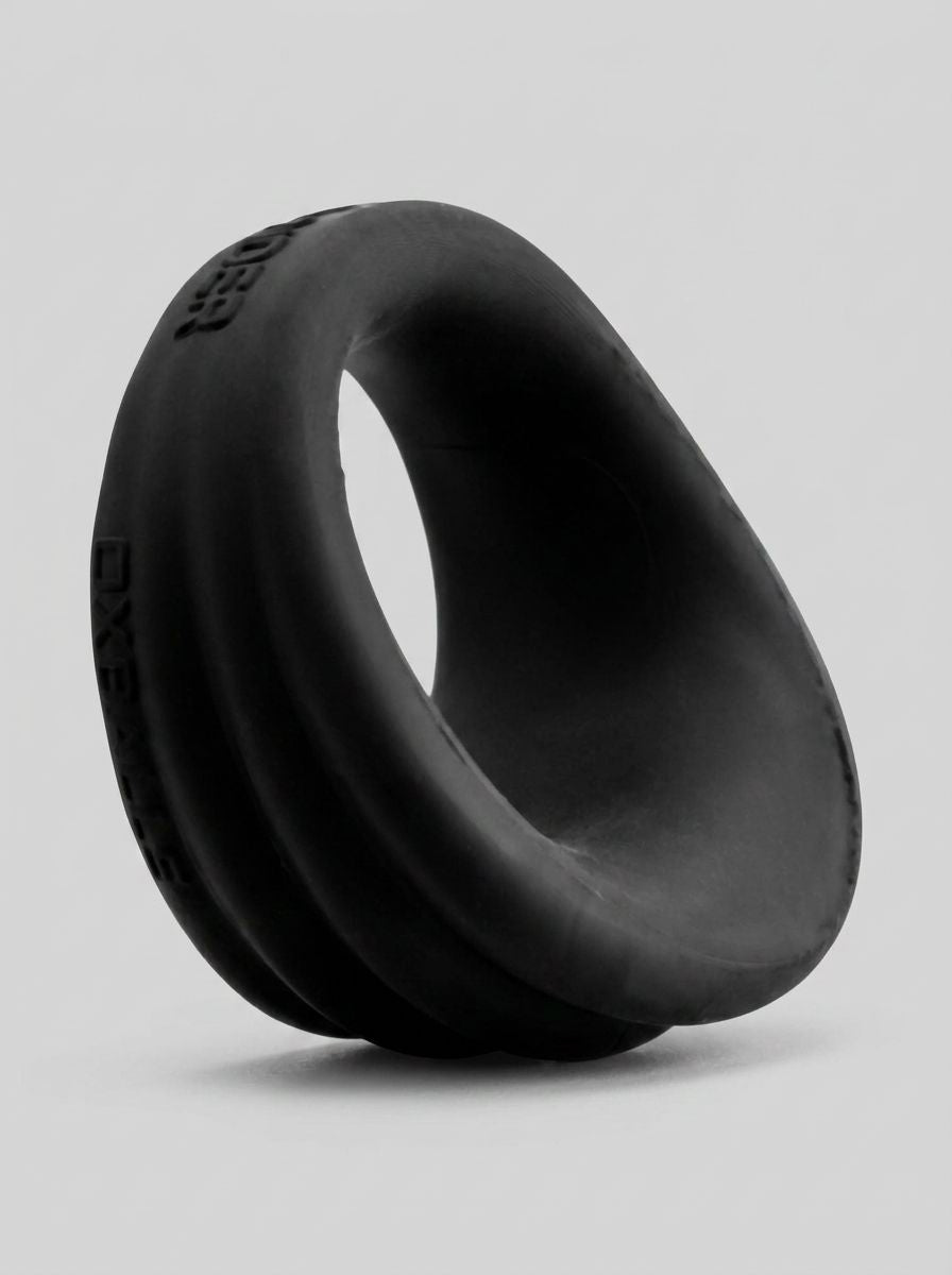 HunkyJunk Expander Silicone Cock & Ball Ring in Black Fog, angled view showing its smooth scoop-shaped cock ring design