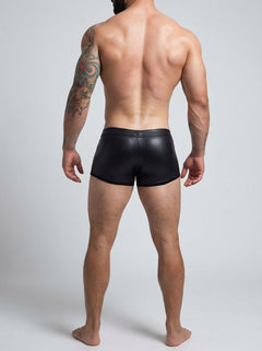 C4M Peekaboo Black Leatherette Mini Pants showcasing a luxurious and modern design with a teasing glimpse of flesh.