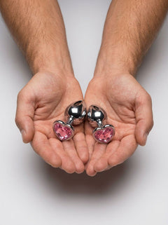 Elegant presentation of the b-Vibe Jewel Metal Training Set emphasizing the duo's eye-catching design for both anal pleasure and visual thrills.