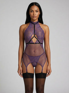 Model displaying the Dreamgirl 3pc Aubergine Lace & Fishnet Garter Slip Chemise, Harness and Thong Set. The luxurious chemise set showcases a sophisticated mix of lace and fishnet for a striking boudoir look.