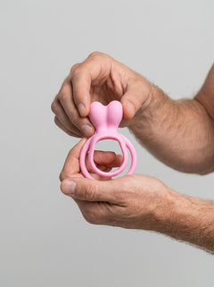 Elegant and flexible JoyRings Silicone Double Rabbit Cock Ring, crafted in pink, designed to stimulate both partners during intimate moments as a premier rabbit cock ring accessory.
