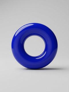 Blue JoyRings Doughnut Stretchy Cock Rings (3 Pack) standing upright, highlighting the glossy finish and rounded shape of these luxury cock rings.