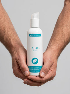 Lifestyle image featuring Me You Us Silk Slix Water Based Lubricant Pump Bottle White 250ml in an intimate setting, emphasizing its role in enhancing pleasure.