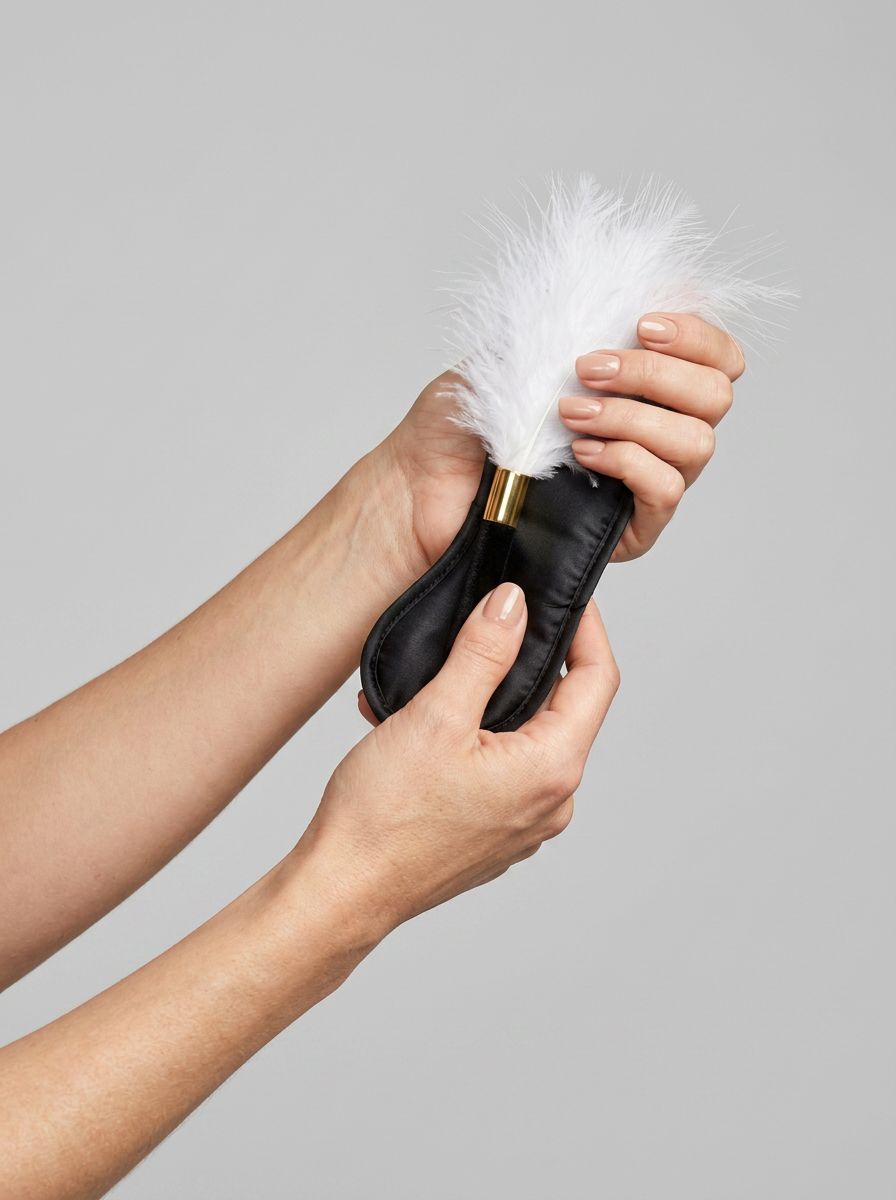 Bound to Play eye mask and feather tickler play kit featuring a black blindfold and feather teaser for sensory play.