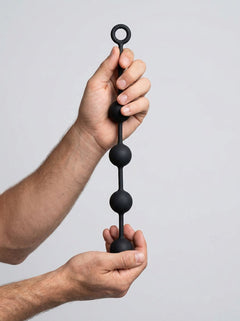 Prowler RED Silicone Anal Beads held in hands, demonstrating the luxurious feel and elegance of anal play.