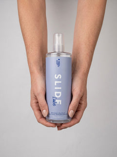 Loving Joy Slide Water-Based Lubricant in a luxurious bathroom setting, ideal for elevating intimate moments with its long-lasting formula.
