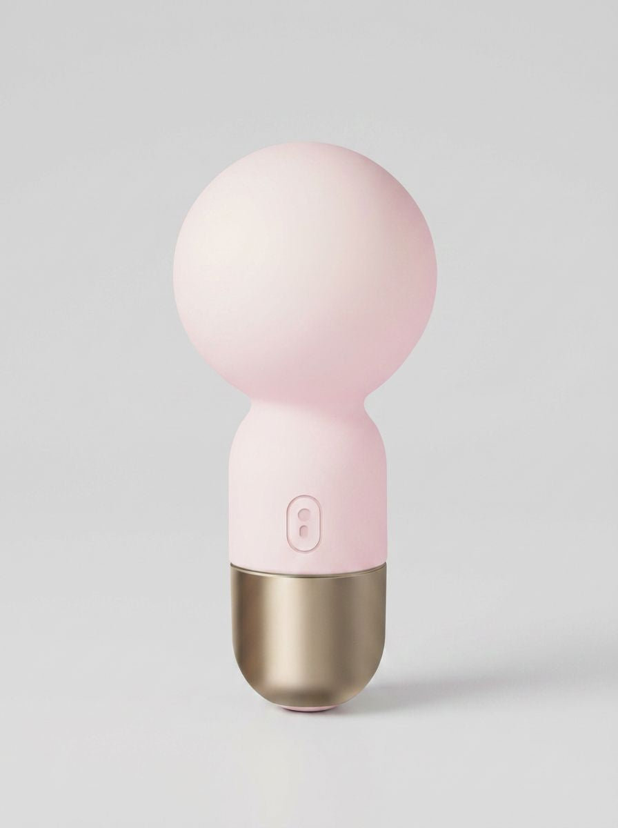 Pokewan Pocket Mini Vibrating Wand Massager in pale pink, shown upright with a rounded head and gold-tone base