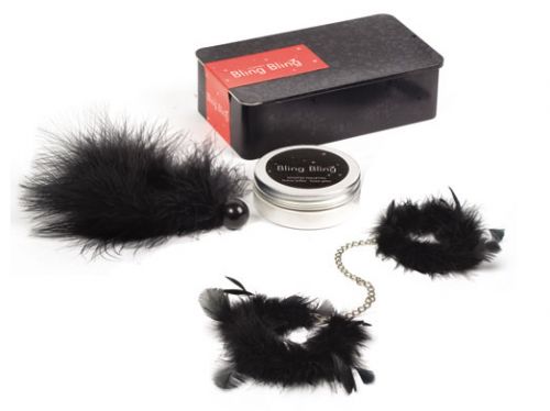 a couple of fake black feathers sitting next to a box