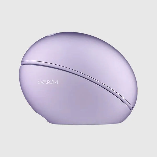 a purple computer mouse sitting on top of a white surface