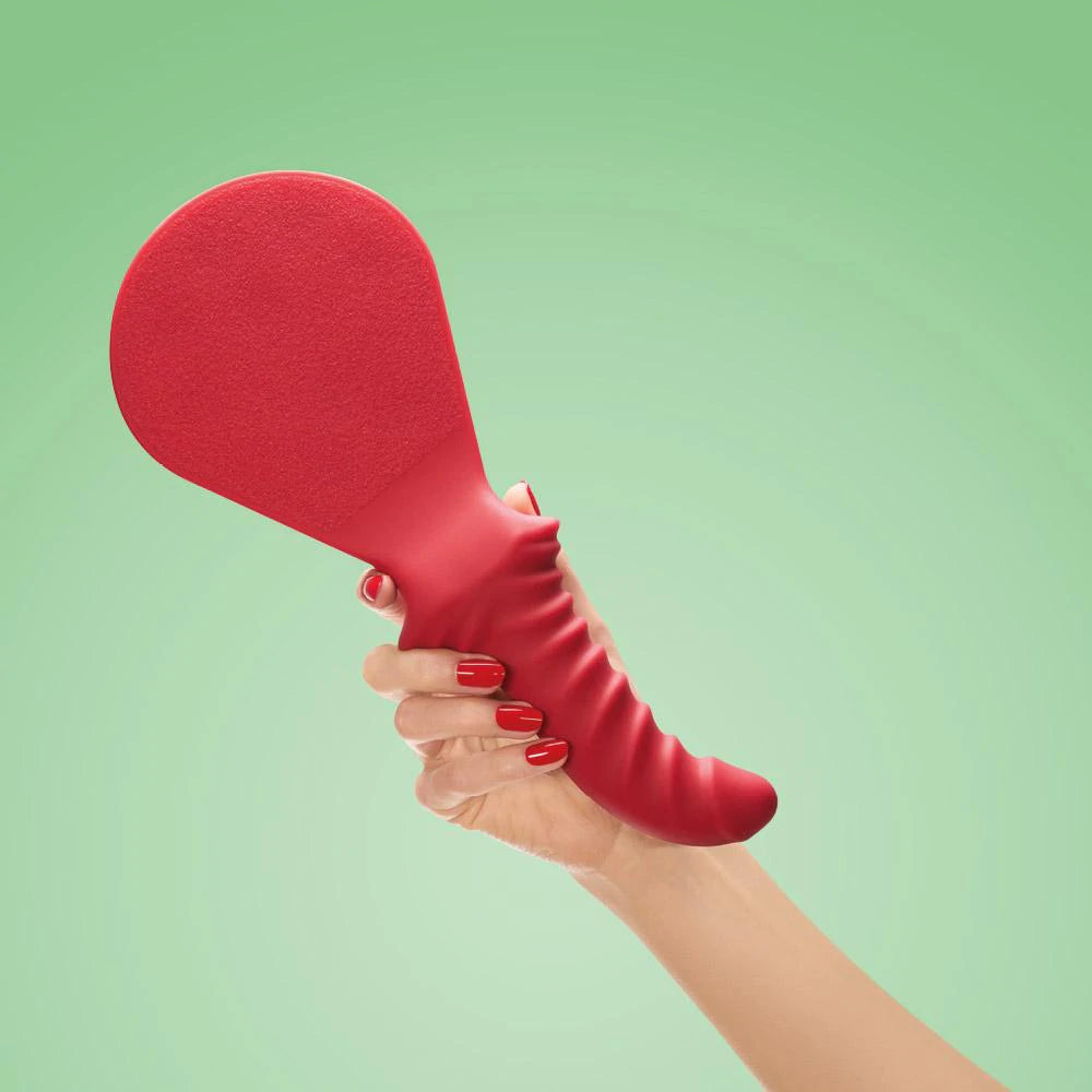 Red Fun Factory BÜCK DICH kinky spanking paddle with integrated dildo, featuring a leather handle and textured surface for sensual play.