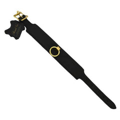 a black strap with a gold ring on it