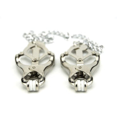 Elegant pair of metallic clover nipple clamps with soft cushioning and a metal chain, designed for luxurious sensory play.