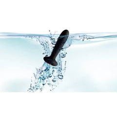a black object floating in water with bubbles