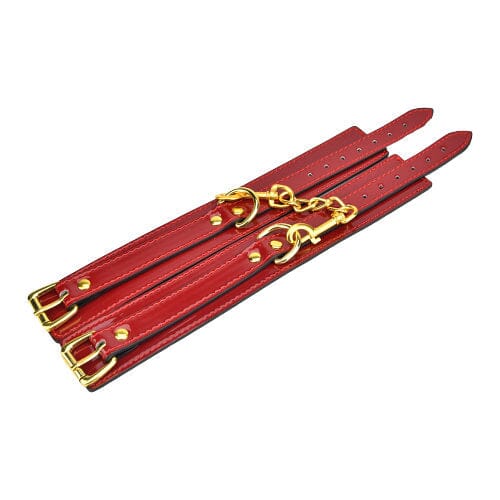 Red Bound to Please ankle cuffs made of soft material, featuring adjustable straps and metal hardware for comfortable wear.