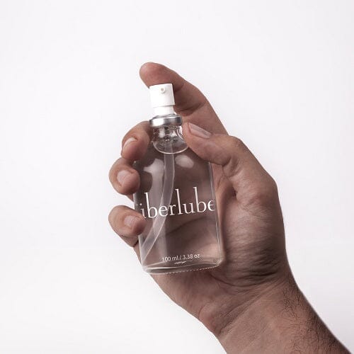a person holding a bottle of perfume in their hand