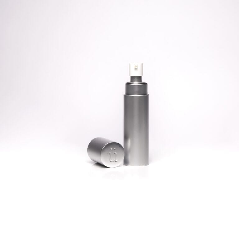 a silver bottle with a white cap on a white background