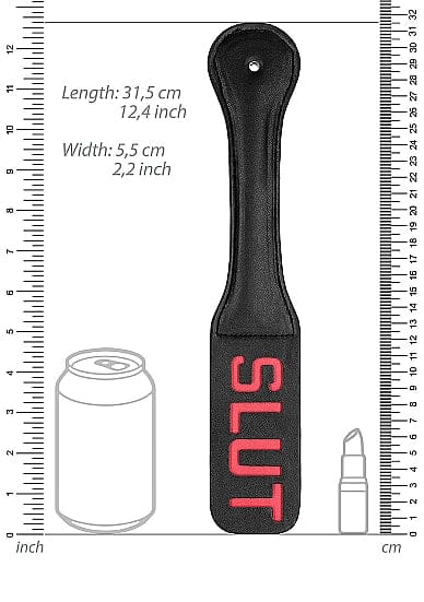 Scandals Paddle SLUT, a black leather spanking paddle with a textured surface and ergonomic handle, shown in side view.