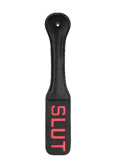 Scandals Paddle SLUT, a wooden spanking paddle with engraved design, shown in a close-up image.